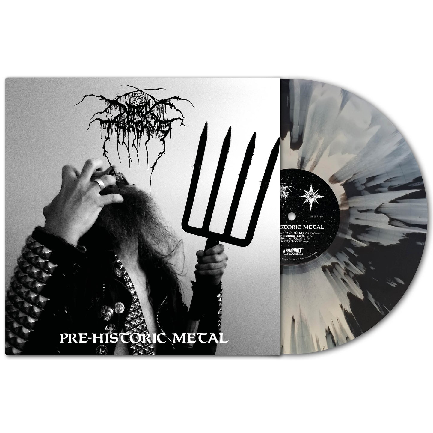 A black and white splatter vinyl by Darkthrone is partially pulled from its sleeve. The album cover features a person in a studded jacket with a pitchfork, making a hand gesture, with "Pre-Historic Metal" and "Darkthrone" written below.