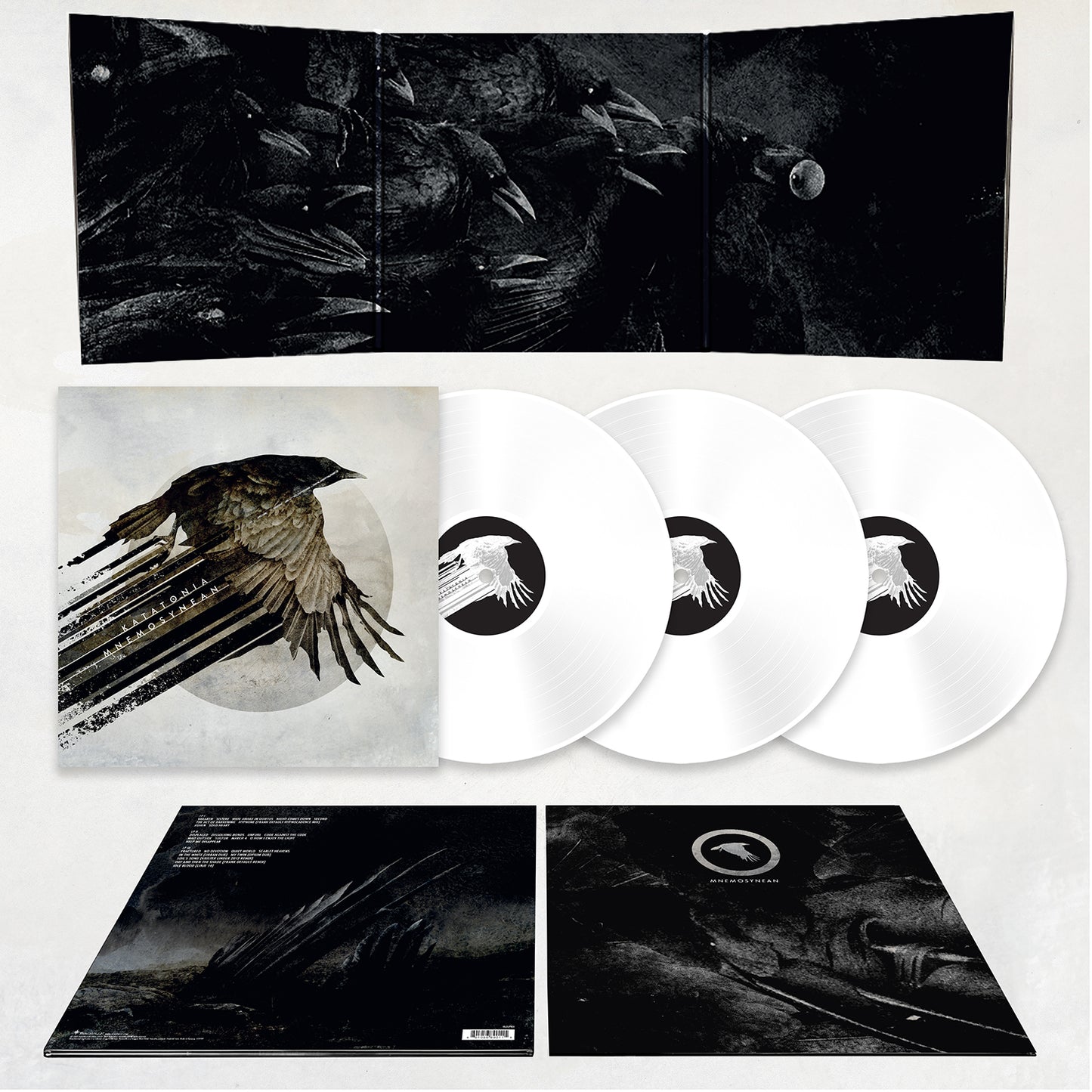 Katatonia white deluxe vinyl box set: includes three white records, a sleeve with a flying black bird, fold-out cover with abstract art and moon, plus inserts featuring rarities and song info.