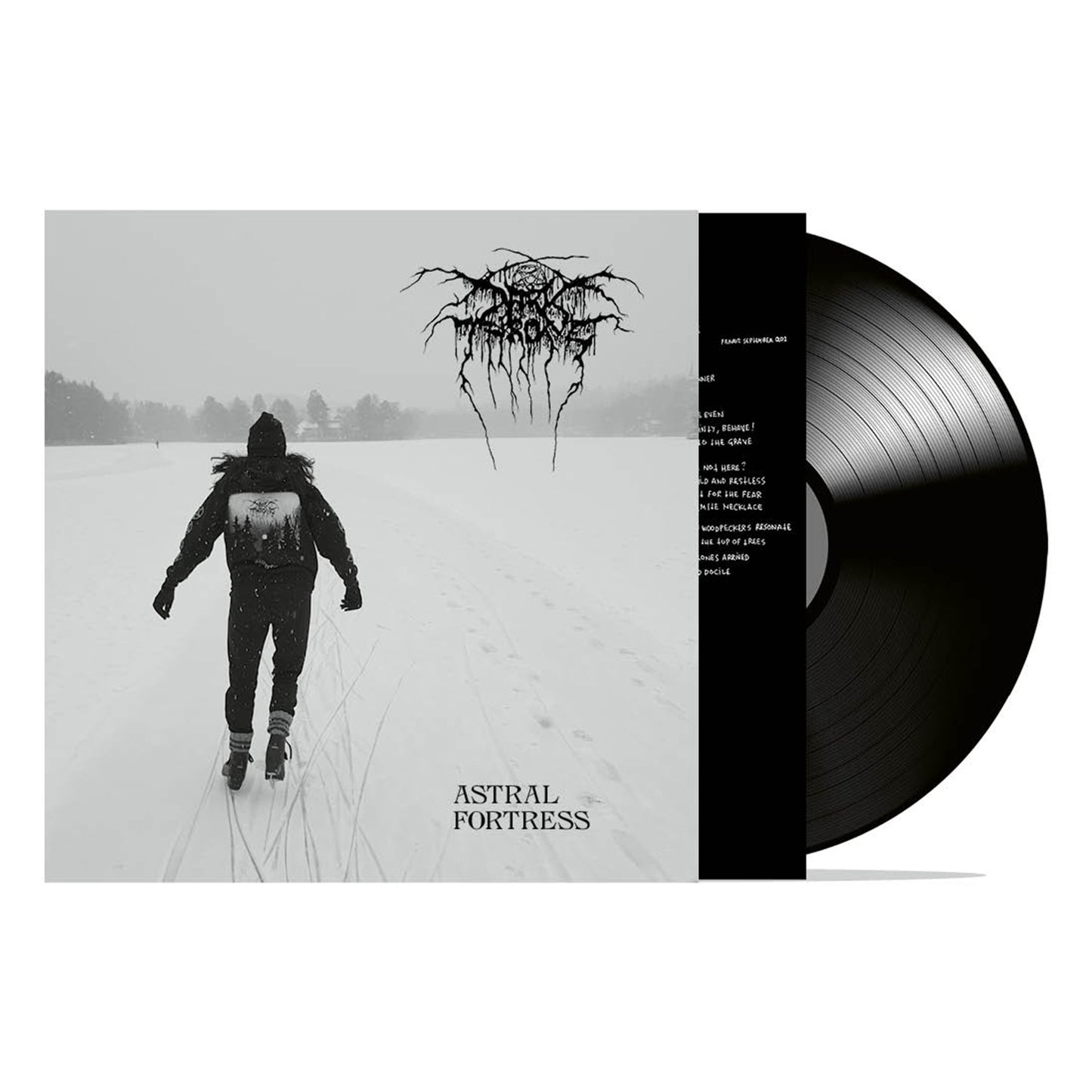 The image shows a Darkthrone vinyl record partly out of its sleeve, featuring a black-and-white photo of someone walking on a snowy field and the album title "Astral Fortress" beneath the band's logo.
