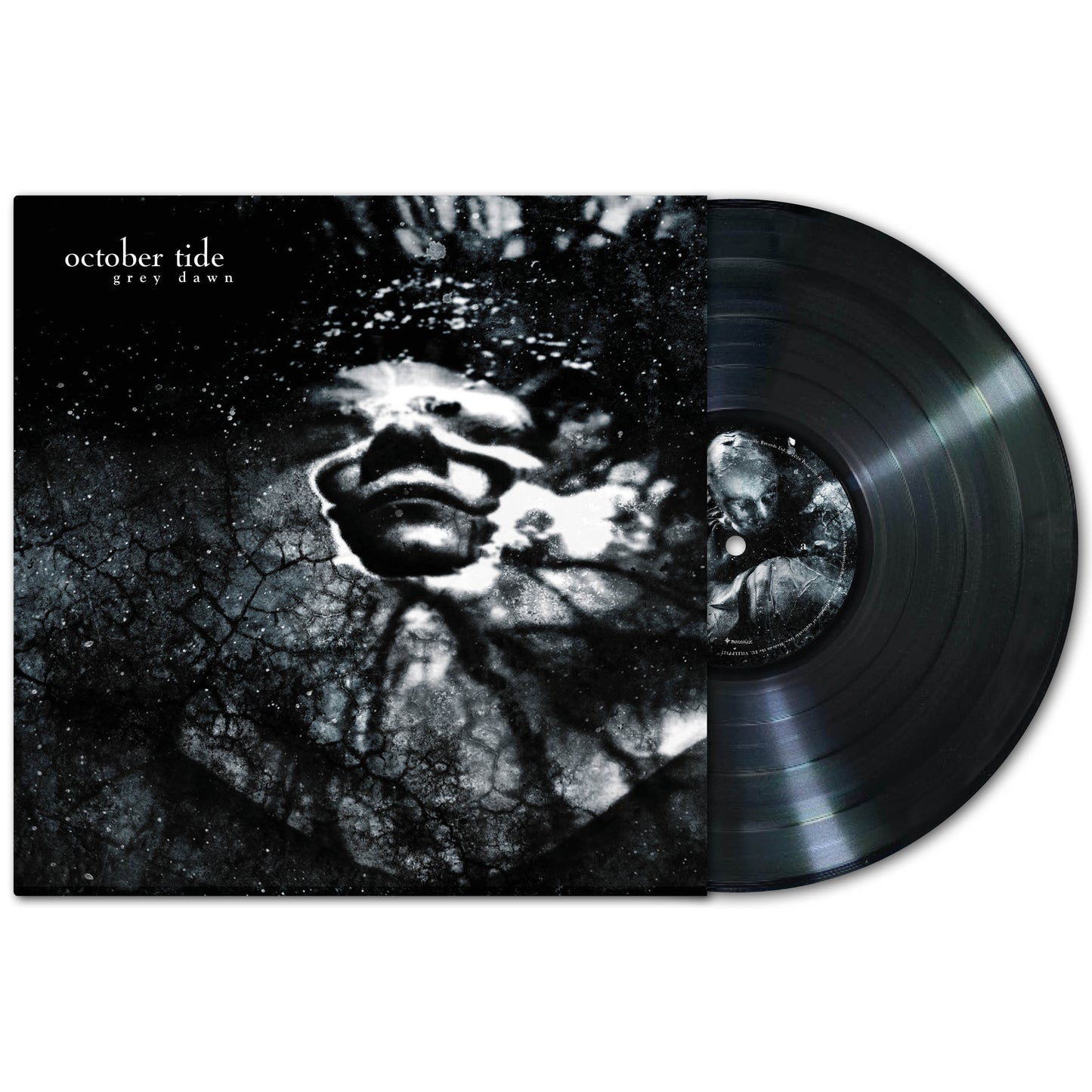 A vinyl record partly out of its sleeve displays October Tide’s Grey Dawn album: dark, abstract artwork showing a face in a cracked, cloudy backdrop, reflecting doom metal's stark black-and-white aesthetic.