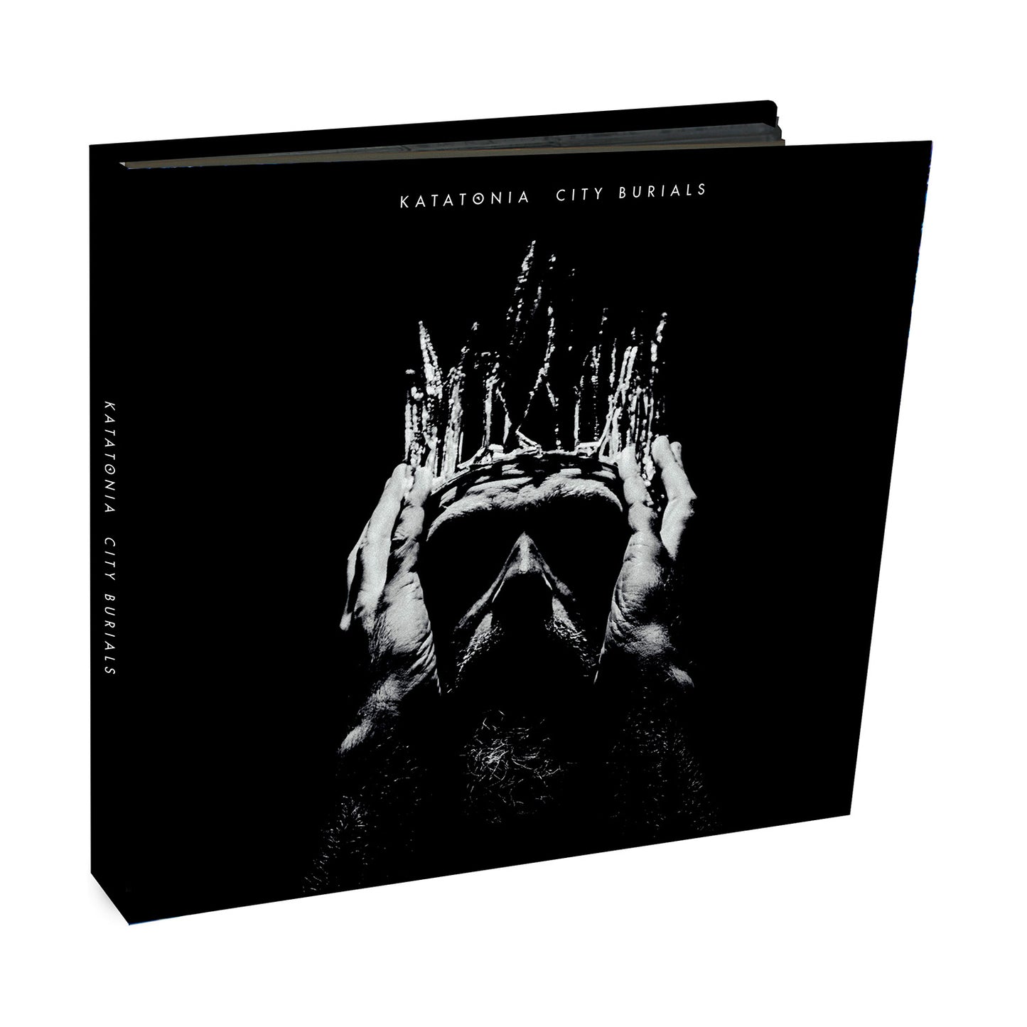 Katatonias City Burials album cover shows a black and white image of a person holding their head, layered with abstract patterns. The design captures the moody essence of progressive rock on a black background with white text.