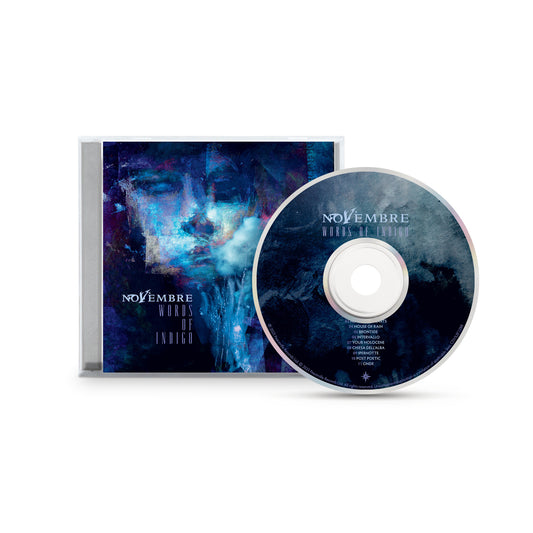 A CD and its case display blue-toned artwork with an abstract, ethereal face and white "Novembre Words of Indigo" text—a dreamy, atmospheric design from acclaimed Italian metal band Novembre.