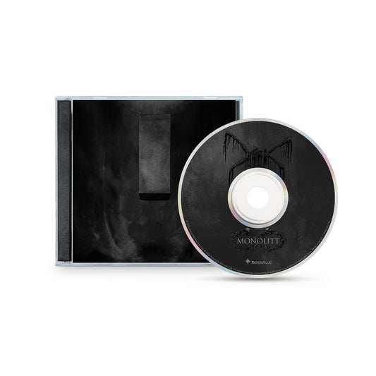 A CD and case by Mork, featuring dark minimalist artwork inspired by Norwegian black metal: a black monolithic rectangle on a smoky background, with the CD reading MONOLITT in a shadowy arch design, evoking brutal darkness.