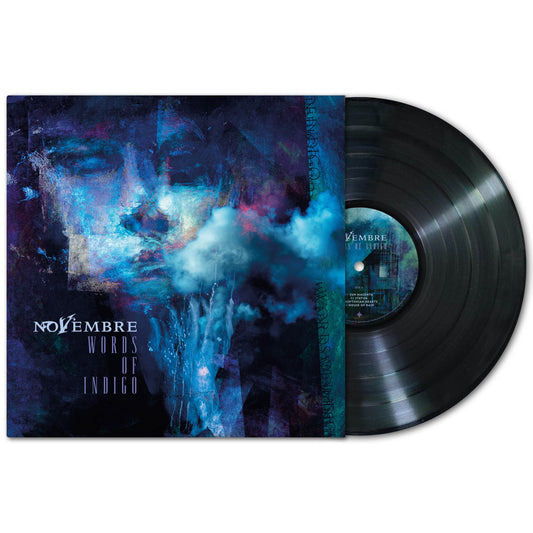 A black vinyl record partly out of its sleeve. The cover shows abstract blue and purple art with a face and swirling smoke, capturing an atmospheric doom metal vibe. Text displays the band name Novembre and album title Words of Indigo.